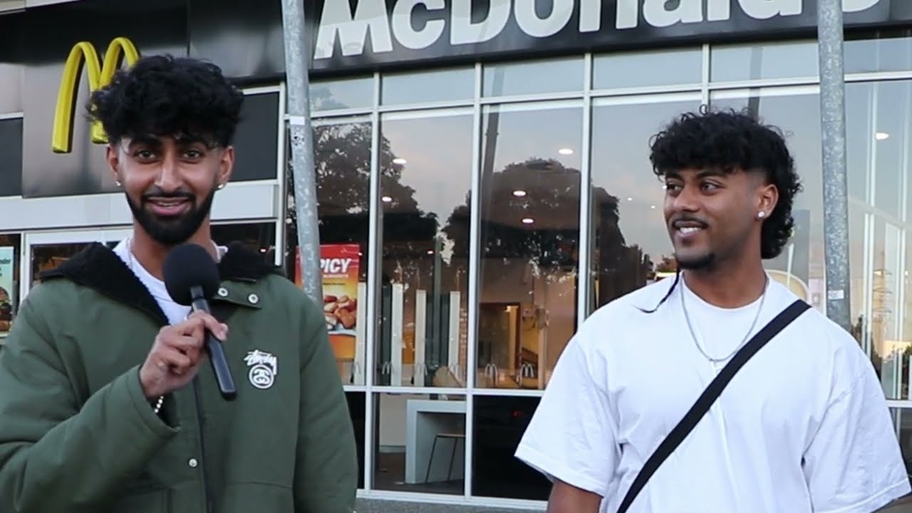 Jay filming a street interview in New Zealand